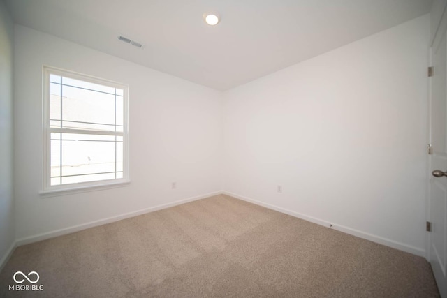 unfurnished room featuring baseboards, visible vents, and carpet flooring