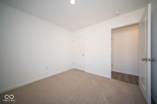 unfurnished bedroom featuring carpet flooring and baseboards