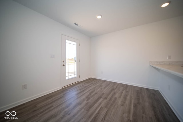 spare room with dark wood-type flooring