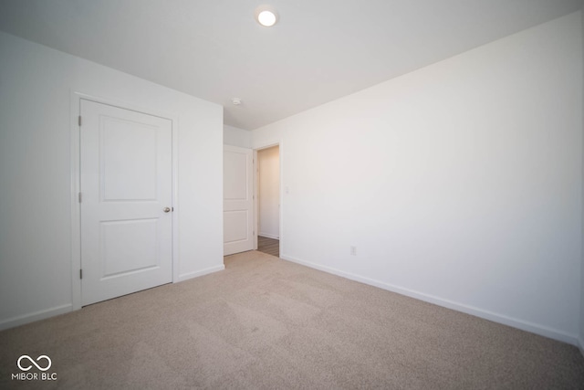 unfurnished bedroom with light colored carpet