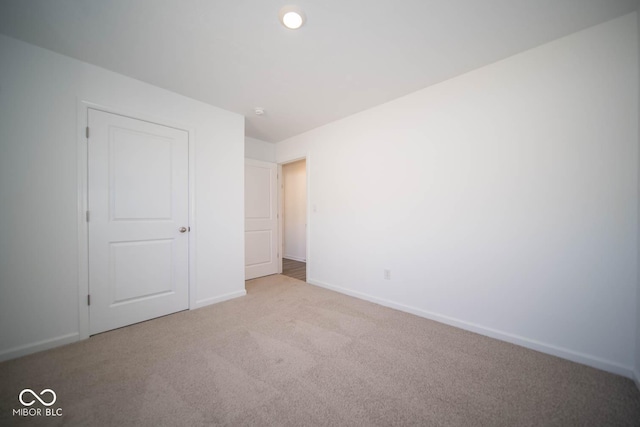 unfurnished bedroom featuring baseboards and carpet