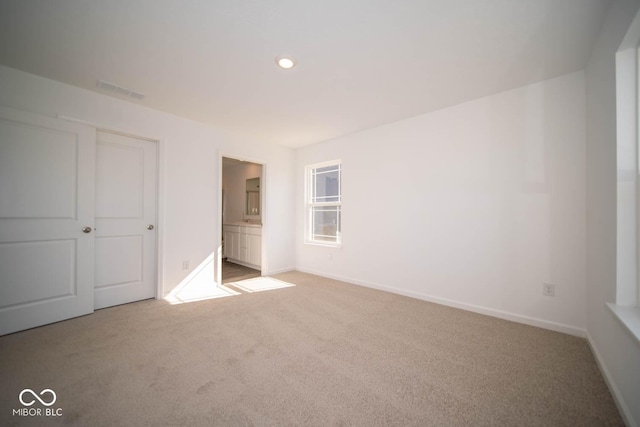 unfurnished bedroom with recessed lighting, carpet flooring, and baseboards