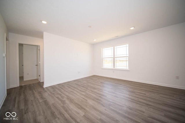 unfurnished room with dark hardwood / wood-style floors