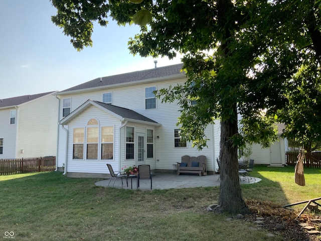 back of house with a yard and a patio area