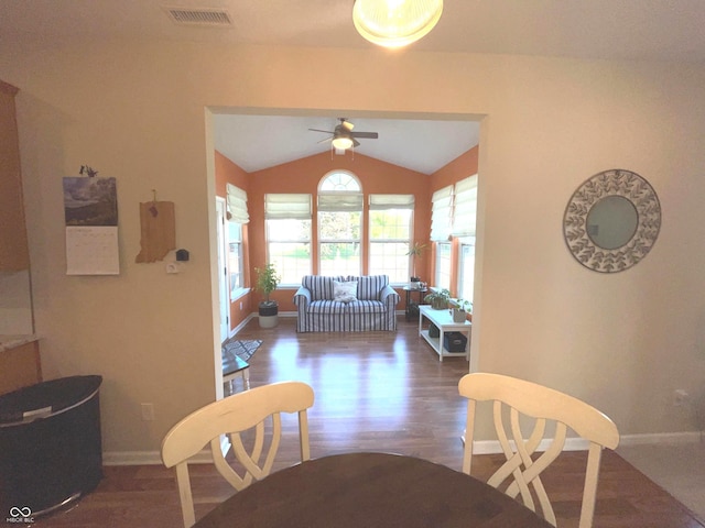 dining room featuring vaulted ceiling, dark hardwood / wood-style floors, and ceiling fan