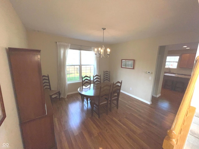 dining space featuring dark hardwood / wood-style floors and a chandelier