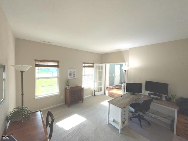 office with light colored carpet and french doors