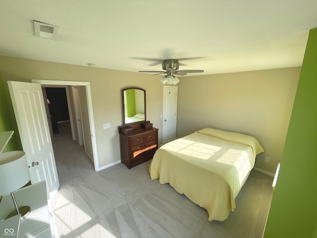 bedroom featuring light colored carpet and ceiling fan