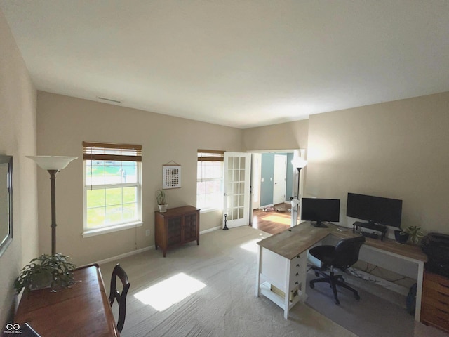 carpeted office space featuring french doors