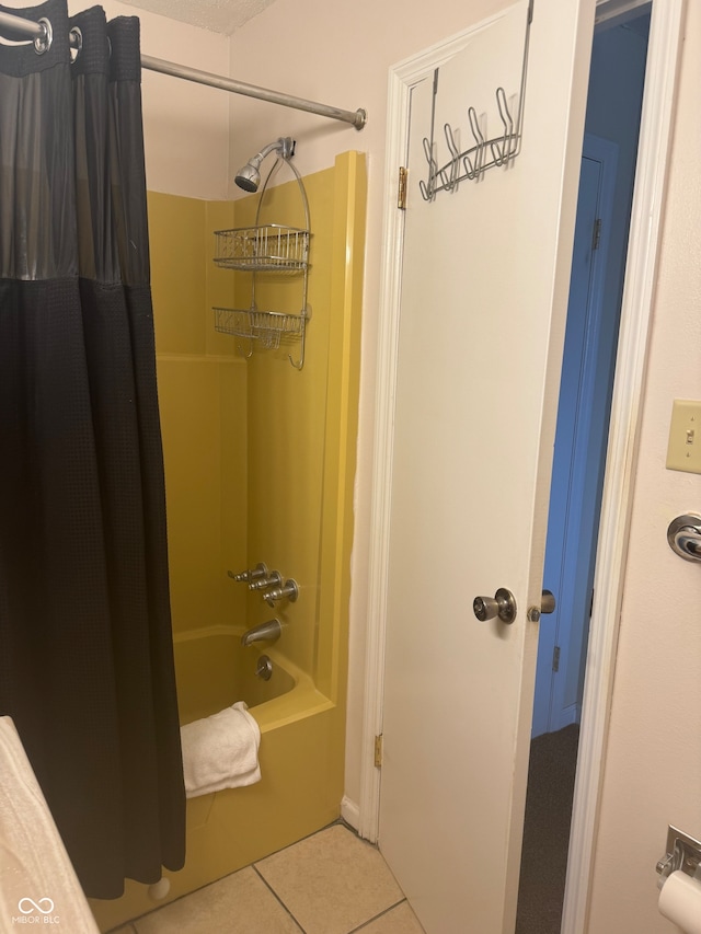 bathroom with tile patterned flooring and shower / bath combo with shower curtain