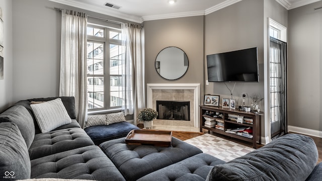 living room with a fireplace, light wood-type flooring, plenty of natural light, and crown molding