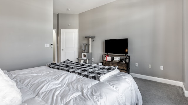 bedroom with carpet floors and high vaulted ceiling