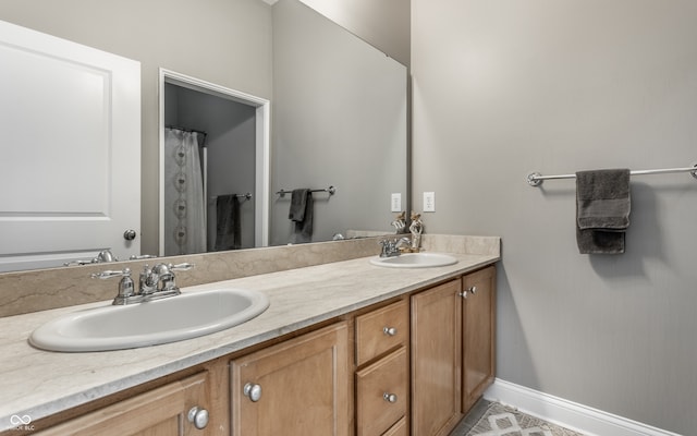 bathroom with tile patterned floors and vanity