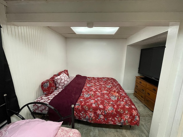 bedroom with a drop ceiling and hardwood / wood-style floors