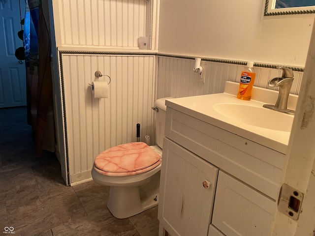 bathroom featuring vanity and toilet