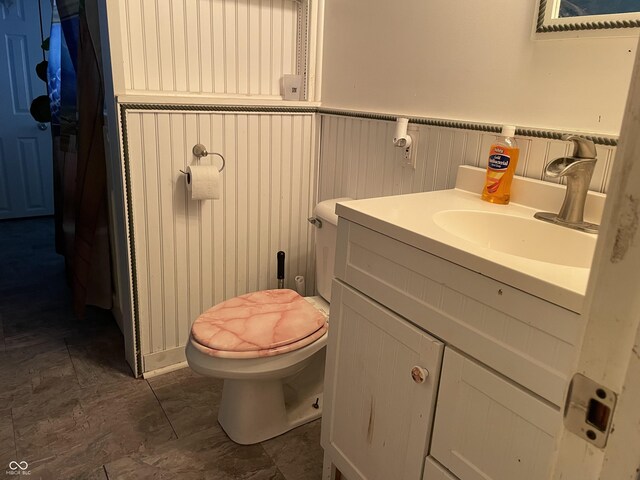 3991 Bennett Dr, Indianapolis, IN 46254 - half bathroom featuring toilet, wainscoting, and vanity