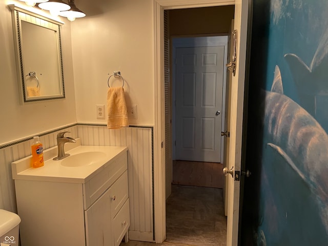 bathroom with vanity, toilet, and wood-type flooring