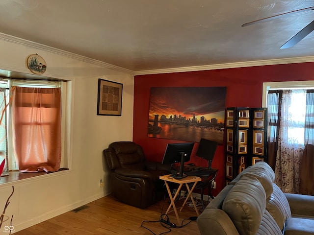 living room featuring hardwood / wood-style flooring and ornamental molding