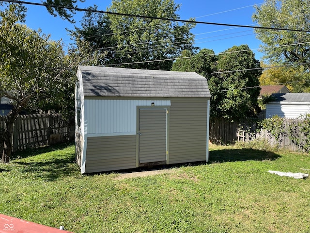 view of outbuilding featuring a lawn