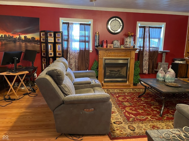 living room featuring crown molding, a healthy amount of sunlight, and hardwood / wood-style floors