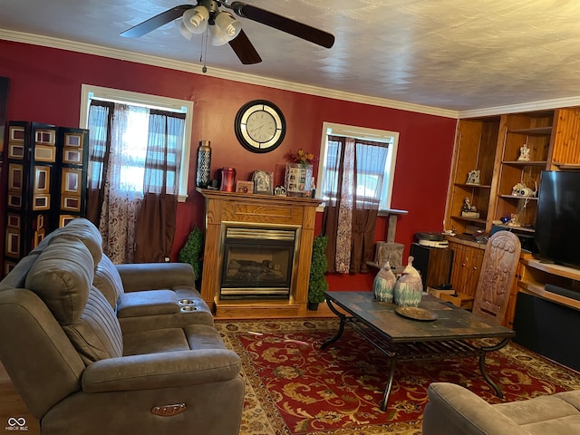 living room with ornamental molding, built in features, and ceiling fan