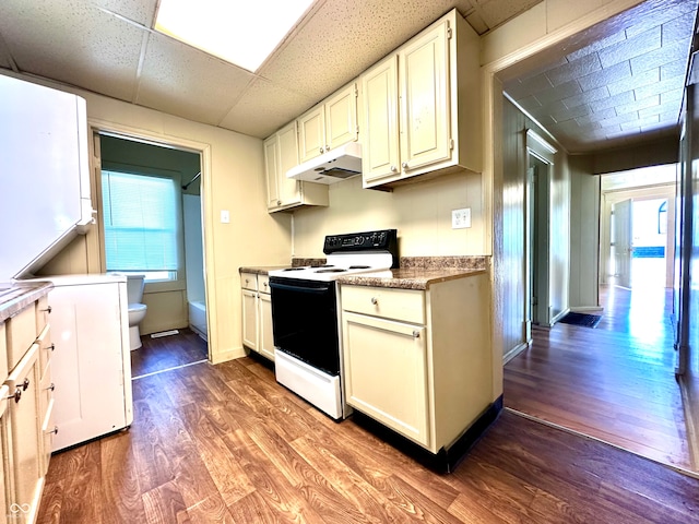 kitchen featuring a drop ceiling, hardwood / wood-style floors, white cabinetry, and white electric stove