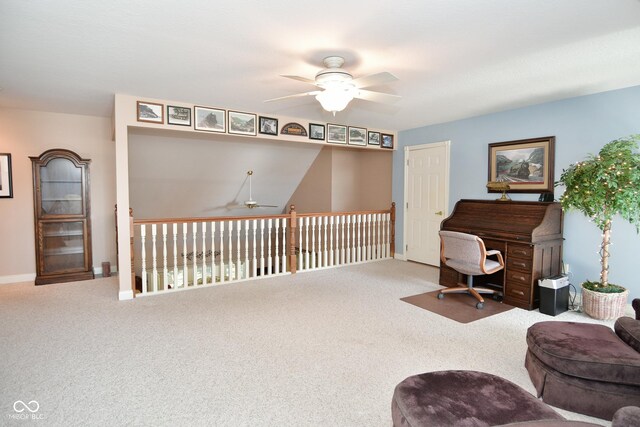 office featuring carpet, a ceiling fan, and baseboards