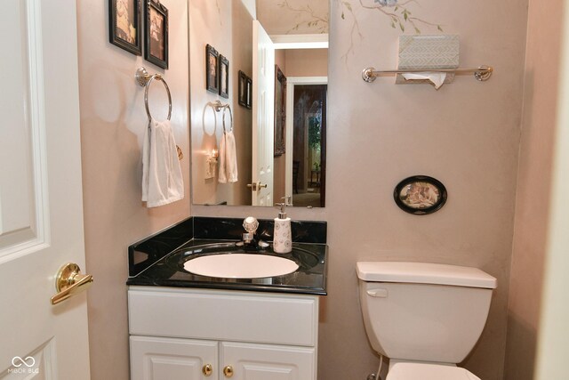 bathroom featuring toilet and vanity