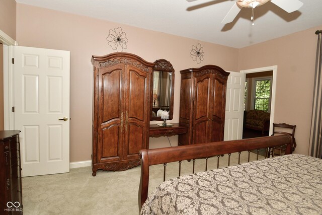 bedroom featuring light carpet and ceiling fan
