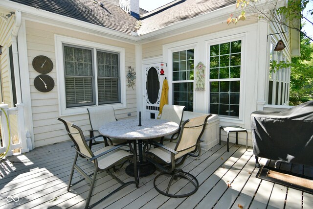 wooden terrace featuring outdoor dining space
