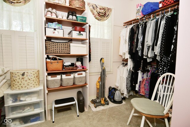 walk in closet with carpet flooring