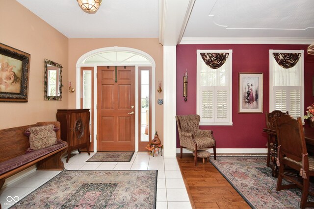 foyer entrance featuring light tile patterned flooring and baseboards