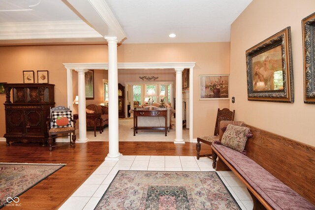 foyer entrance with french doors, light tile patterned flooring, recessed lighting, ornate columns, and ornamental molding