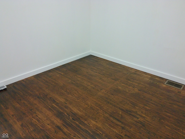 unfurnished room featuring dark hardwood / wood-style floors