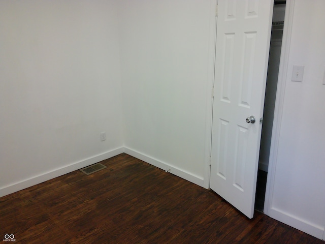 spare room with dark hardwood / wood-style floors