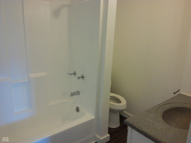 full bathroom featuring vanity, toilet,  shower combination, and hardwood / wood-style flooring