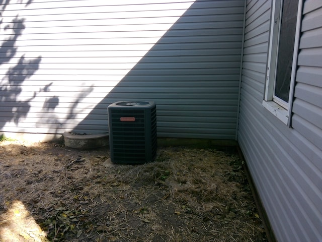 exterior details featuring wooden walls and central air condition unit