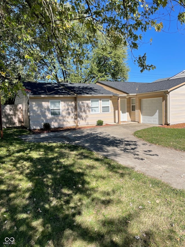 single story home with a front yard and a garage