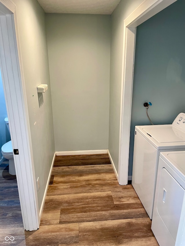 washroom with hardwood / wood-style floors and independent washer and dryer