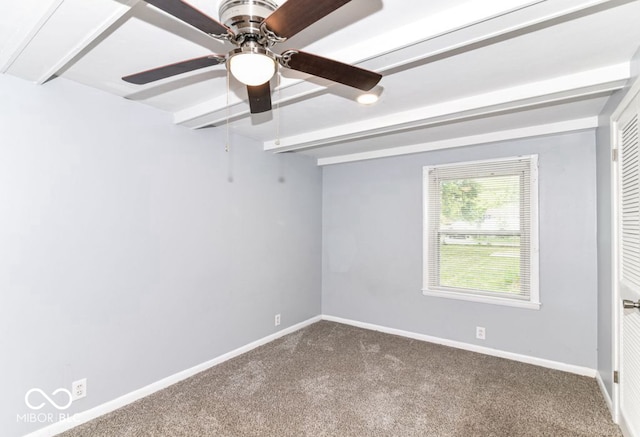 carpeted empty room with ceiling fan and beamed ceiling