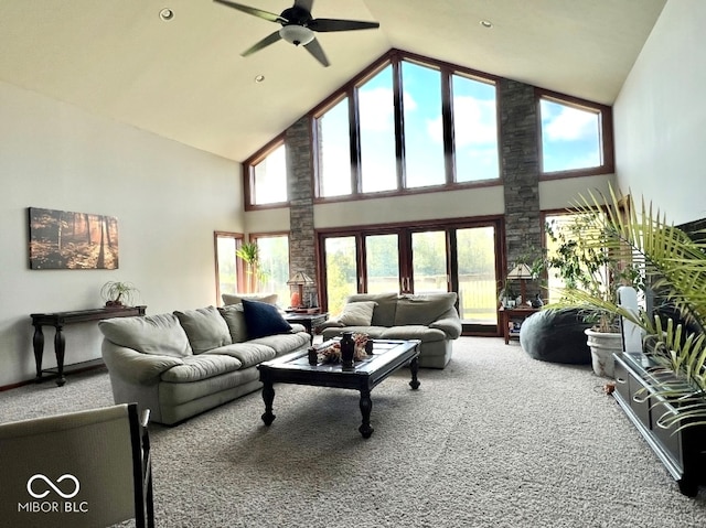 carpeted living room with ceiling fan, high vaulted ceiling, and a wealth of natural light