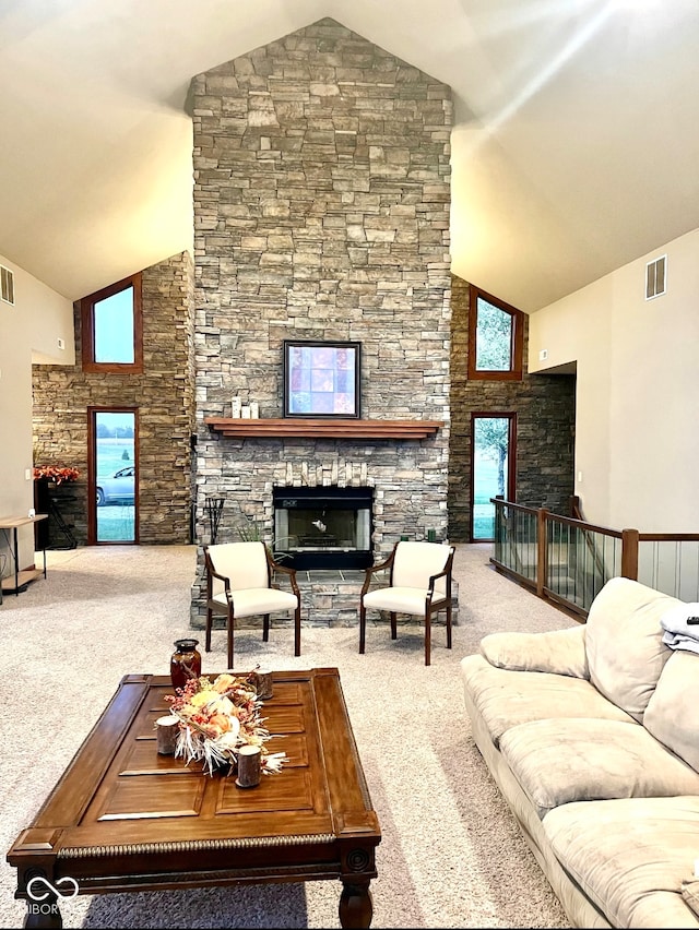 living room featuring high vaulted ceiling, carpet floors, and a stone fireplace