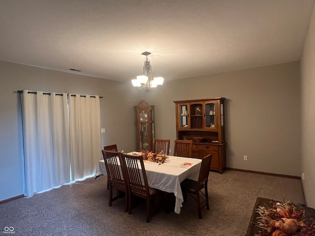 dining room featuring dark carpet and a notable chandelier