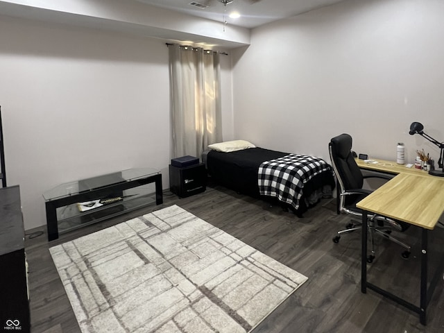 bedroom with dark hardwood / wood-style flooring