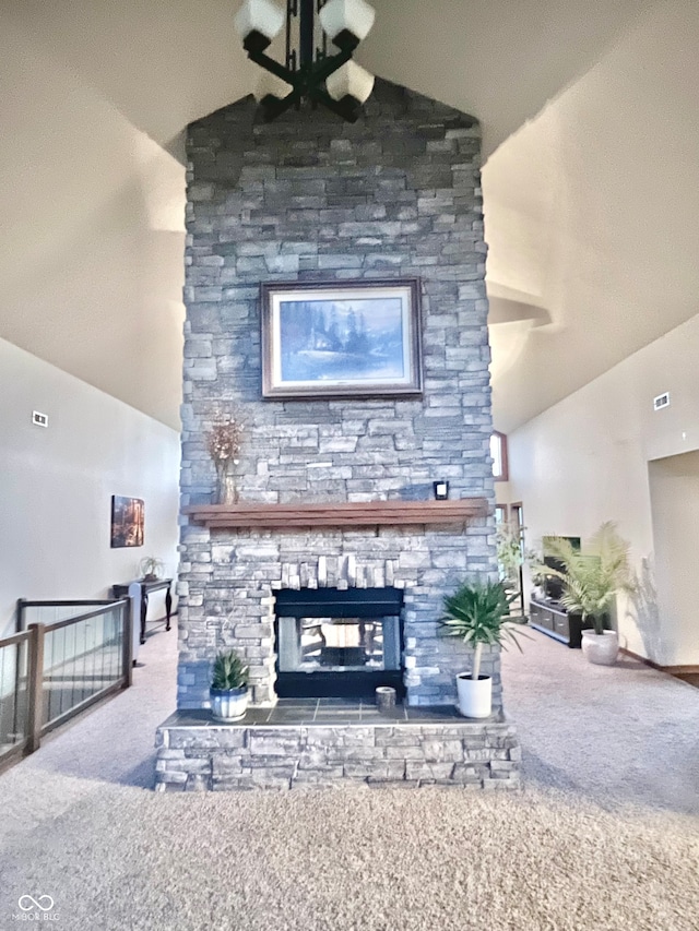 carpeted living room featuring lofted ceiling, a notable chandelier, and a fireplace