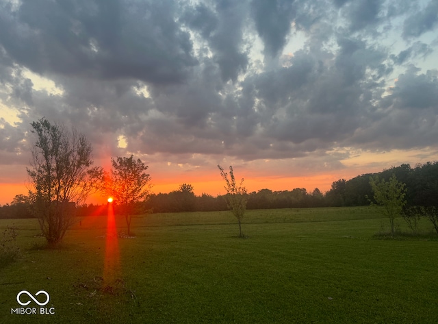 yard at dusk with a rural view