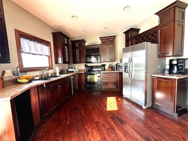 kitchen featuring black appliances, dark hardwood / wood-style flooring, and sink