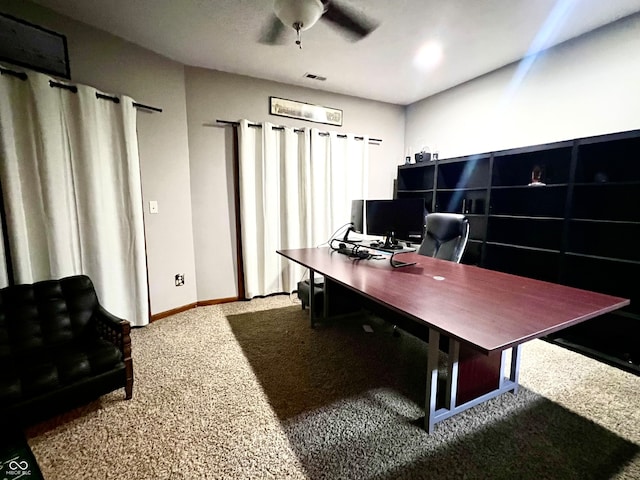 carpeted office space with ceiling fan