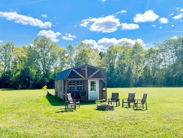 exterior space with a fire pit and an outdoor structure