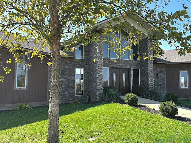 view of front of property featuring stone siding and a front yard